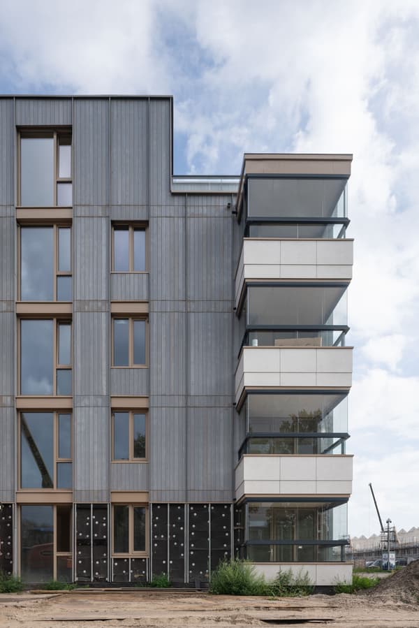 Architectural project - multi-story building, vertical lines, gray, metal cladding, cladding, minimalistic look, minimal design, natural materials, wood, city living, grey tones, metal, outdoor space, glass, modular construction, eco design, green building, sustainable architecture, urban development, beige, concrete, low carbon design, daylight optimization, contemporary design, neutral palette, passive house, modern facade, clean lines, energy efficient, timber accents, environmental design, residential building, balcony design, sustainable facade, cutting-edge design, building envelope, apartment building, modern urban, urban facade, urban living, architectural innovation