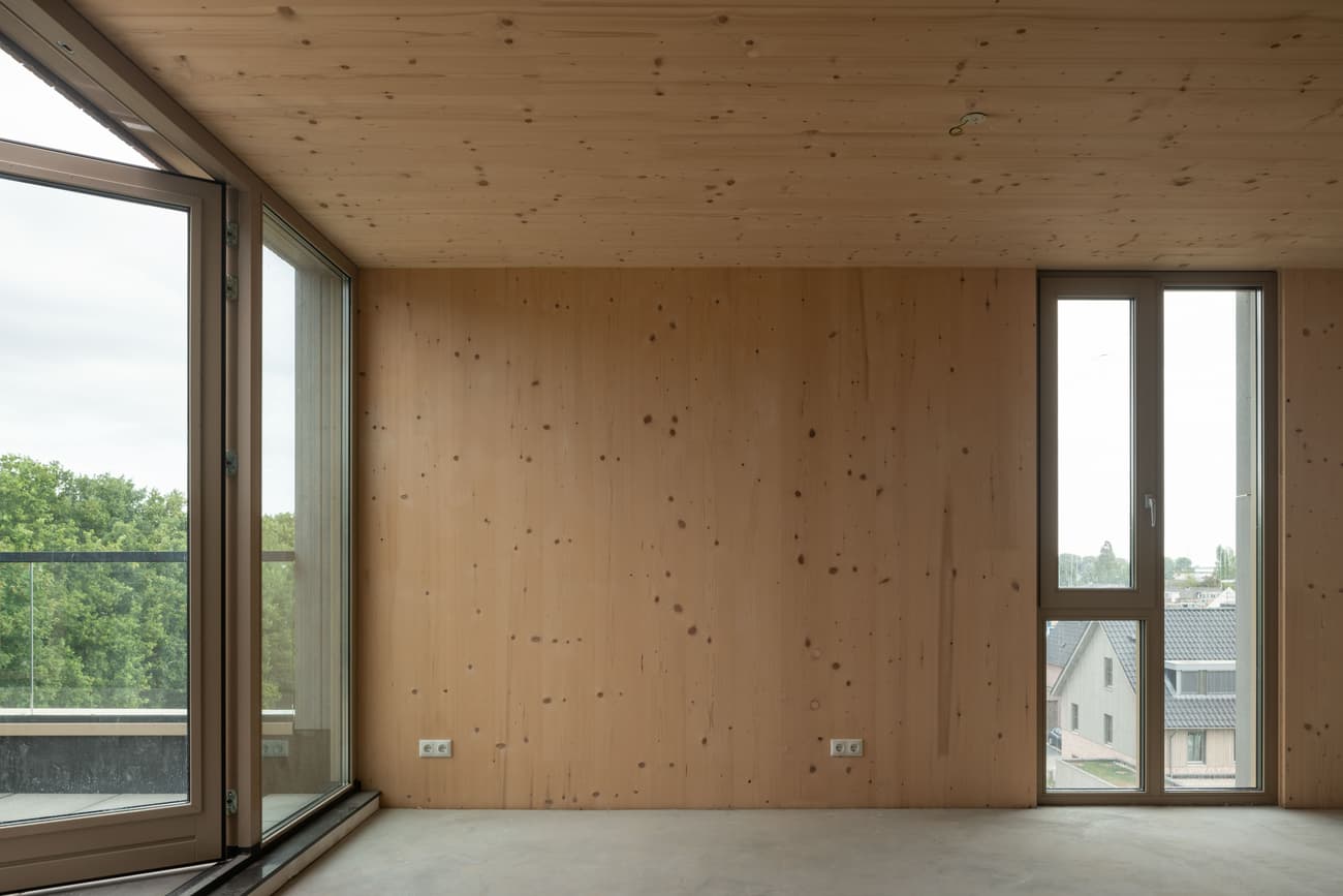 Architectural project - balcony access, modern space, minimal design, warm interior, natural materials, raw materials, natural light, sustainable design, modular design, sustainable architecture, daylight, light wood, engineered wood, timber construction, simple design, honey wood, minimalist vibe, Scandinavian style, neutral palette, glass doors, timber panels, timber walls, wood panels, exposed wood, biophilic design, eco home, sustainable home, passive house, large windows, timber cladding, wood cladding, eco friendly home, cozy vibe, wood walls, beige tones, timber interior, open layout, open plan, living area, inviting space, earthy tones, exterior view, minimalist space, residential space, bright interior, nordic influence, modern living, airy feel, floor to ceiling, indoor outdoor flow, wood interior