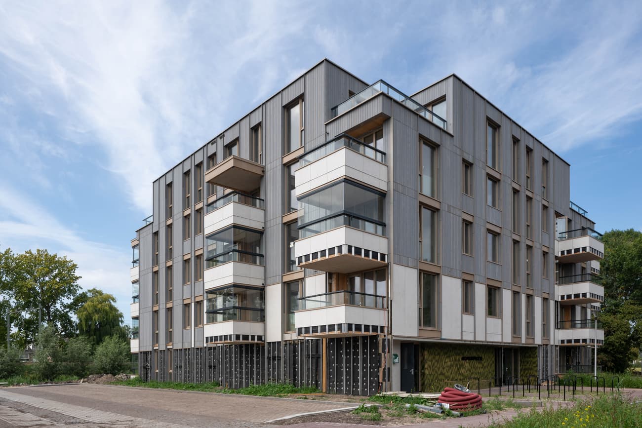 Architectural project - urban greenery, residential complex, urban residential, grey facade, angular architecture, timber, steel, natural light, glass, modular design, eco design, contemporary architecture, sustainable architecture, grey, neutral tones, city building, concrete, timber facade, low carbon design, engineered wood, functional design, daylight optimization, Scandinavian style, minimalist design, residential development, passive house, modern facade, wood cladding, eco friendly home, energy efficient, Nordic influences, residential building, sleek design, compact living, efficient layout, green surroundings, architectural rhythm, sustainable living, apartment building, modern urban, urban living, urban housing