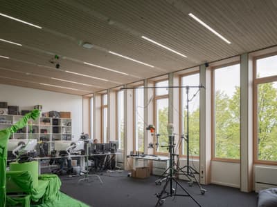 Architectural project - multitasking space, creative studio, ergonomic design, relaxing environment, modern office, collaborative area, office studio, open workspace, workstation, office equipment, tech setup, ceiling slats, grey carpet, acoustic panels, tech-friendly, computer setup, inspiring workspace, matte finish, minimal design, wood, timber, grey tones, natural light, sustainable design, glass, eco design, green building, neutral tones, daylight, light wood, modern aesthetic, honey wood, Scandinavian style, workspace, biophilic design, passive house, natural ventilation, large windows, Nordic design, outdoor view, energy efficient, timber interior, open plan, panoramic view, eco-friendly building, bright interior, wood ceiling