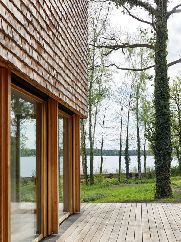 Architectural project - natural materials, wood, timber, grey, natural light, passive design, glass, warm tones, daylight, beige, brown, wood facade, timber facade, eco friendly, natural setting, simple design, Scandinavian style, serene space, natural palette, biophilic design, eco home, indoor outdoor, timber cladding, timber house, Nordic style, large window, landscape view, energy efficient, rustic style, open plan, inviting space, earthy tones, cozy atmosphere, nature retreat, forest view, timber deck, peaceful vibe, sustainable cabin, nature integration, green design, rustic retreat, lakeside view, wooden house, shingle, wooden cladding, shingle siding, shingle facade, wood siding, waterfront view, lake cabin, eco retreat, outdoor deck, wooden deck, glass door, floor to ceiling glass, wooden textures, rustic textures