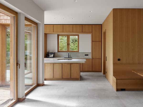 Architectural project - indoor space, natural materials, wood, timber, raw materials, grey, natural light, sustainable design, glass, warm tones, neutral tones, daylight, beige, light wood, eco friendly, simple design, Scandinavian style, minimalist style, neutral palette, glass doors, clean lines, large windows, Nordic design, energy efficient, wood accents, timber accents, home kitchen, open layout, open plan, dining area, inviting space, earthy tones, cozy atmosphere, residential space, minimalist kitchen, modern kitchen, wood cabinetry, timber cabinetry, breakfast nook, sleek design, functional layout, kitchen island, built-in seating, bright space, compact kitchen, practical space, timeless design, calm atmosphere, interior