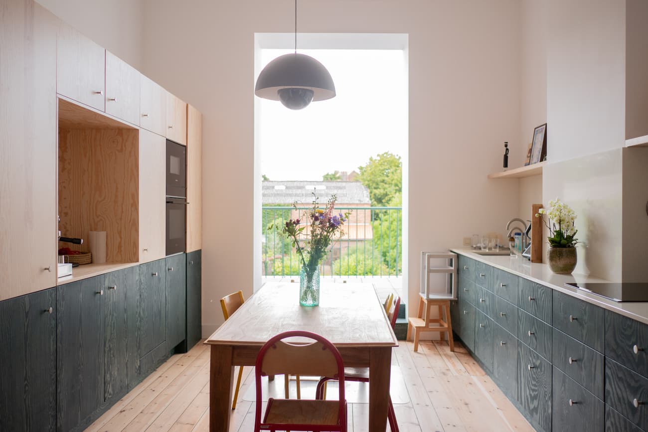 Architectural project - home decor, simple aesthetic, residential kitchen, cozy dining, natural decor, light wood floor, sleek cabinets, colorful chairs, modern lighting, wooden cabinets, indoor space, wood, timber, natural light, sustainable design, grey, daylight, plywood, beige, light wood, eco friendly, minimalist vibe, serene atmosphere, contemporary design, neutral palette, black, clean lines, white walls, white, Nordic style, green living, family kitchen, bright kitchen, open layout, wooden table, dining table, inviting space, Scandinavian design, minimalist kitchen, practical space, soft tones, open space, functional kitchen, wood flooring, interior design, kitchen, minimalist shelves, pendant lamp, urban view, airy, kitchen renovation