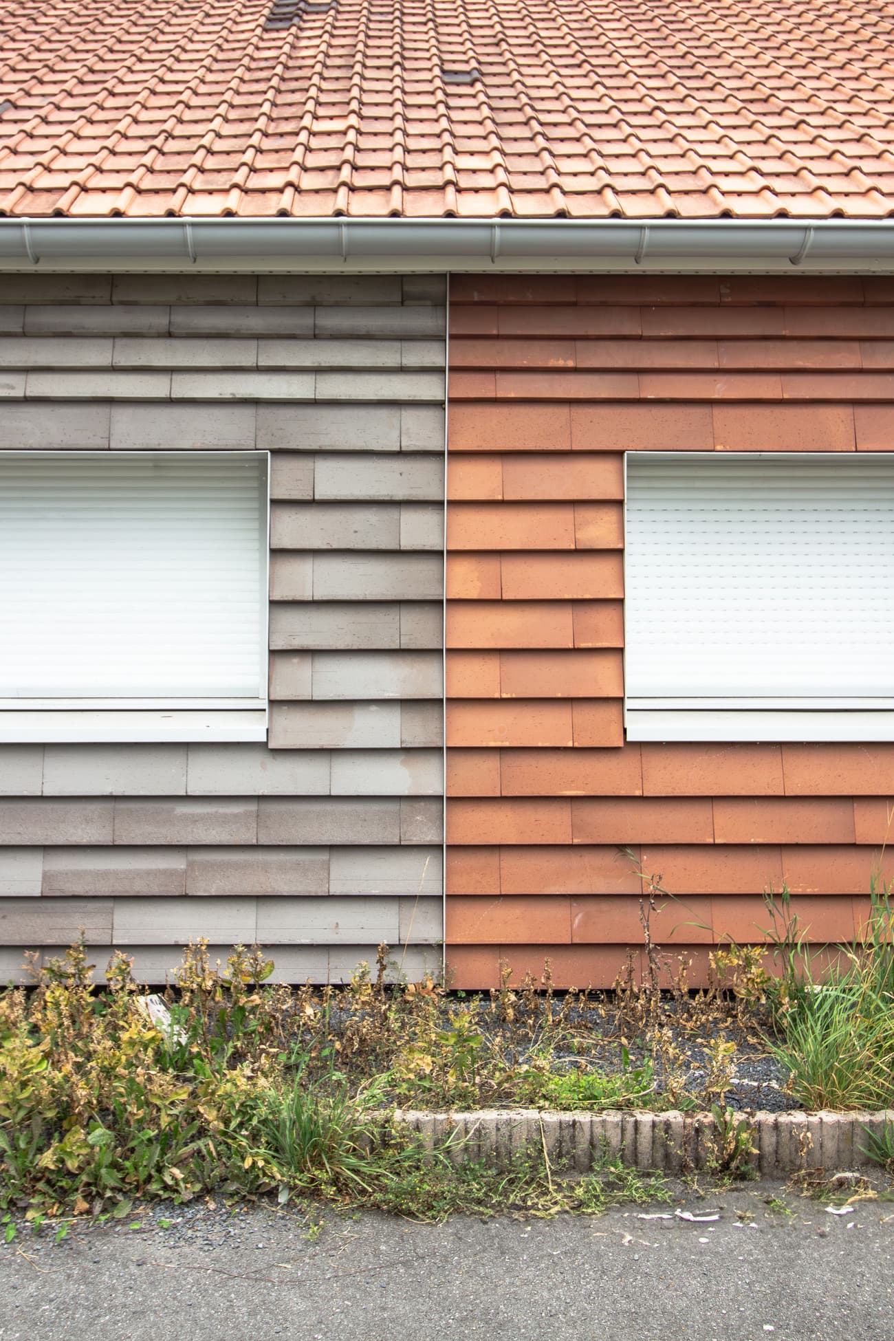 Architectural project - shutter windows, mixed facade, contrast design, grey siding, orange siding, red-orange, garden border, functional windows, dual tone, siding contrast, facade materials, low maintenance, simple landscaping, subtle contrast, terracotta roof, two-tone facade, building texture, exterior aesthetic, contemporary housing, horizontal cladding, architectural detail, sustainable materials, warm tones, grey, neutral colors, clean lines, earthy tones, brick facade, residential building, facade texture, modern exterior, green landscaping, suburban home, clay tiles, home renovation, mixed materials, exterior cladding, eco facade, urban housing