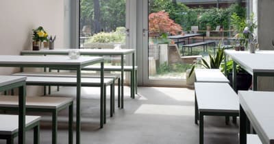 Architectural project - green accents, urban cafe, vibrant plants, fresh vibe, modern cafe, metal frame, metal, natural light, sustainable design, glass, contemporary style, grey, green, neutral tones, daylight, concrete, eco friendly, industrial touch, minimalist design, social space, public space, pastel green, light tones, large windows, indoor outdoor, white, open plan, inviting space, casual dining, cozy atmosphere, relaxed setting, outdoor connection, greenery, garden view, green design, bright interior, sliding doors, concrete floor, simple furniture, indoor plants