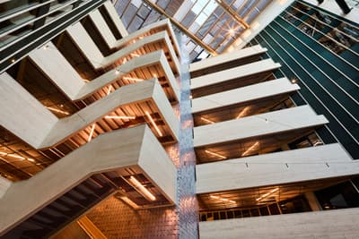 Architectural project - vertical windows, open ceiling, angular design, metal detailing, glass elements, raw aesthetics, sleek interior, lobby, multipurpose space, high rise, office building, geometric patterns, natural materials, sustainable design, warm tones, exposed structure, grey, beige, brown, light wood, engineered wood, daylight optimization, eco friendly, wooden beams, contemporary design, minimalist design, black, urban design, industrial chic, CLT, cross laminated timber, natural ventilation, modern facade, large windows, timber cladding, modern architecture, eco architecture, wooden facade, public building, warm lighting, atrium, structural rhythm, urban vibe