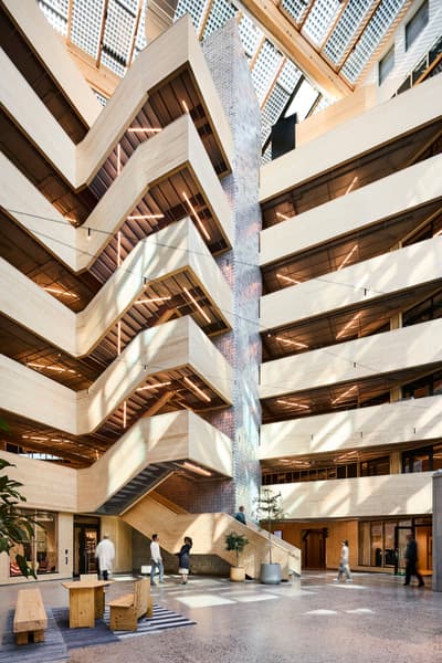 Architectural project - wooden benches, skylights, polished concrete, communal area, multi-level, glass ceiling, wood, timber, natural light, passive design, sustainable design, glass, warm tones, green building, exposed structure, contemporary style, neutral tones, daylight, beige, concrete, light wood, public space, gathering area, social hub, urban design, eco-friendly materials, timber elements, white, modern architecture, open plan, concrete floor, open space, structural elements, interior architecture, tactile surfaces, indoor plants, mixed materials, atrium, architectural feature