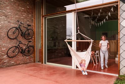 Architectural project - Scandinavian touch, exposed brick, brick house, playful area, brick walls, covered terrace, natural materials, eco-friendly design, wood, timber, natural light, outdoor living, glass, warm tones, neutral tones, daylight, beige, concrete, light wood, modern design, honey wood, rustic charm, minimalist style, relaxed atmosphere, gathering area, earth tones, modern rustic, sustainable home, modern facade, indoor outdoor, cozy vibe, timber ceiling, green living, casual living, open plan, family space, brick, family home, wood ceiling, welcoming space, sliding glass doors, urban living, red, outdoor terrace