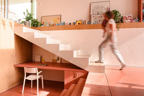 Architectural project - modern staircase, efficient use, Nordic touch, white steps, pink floor, minimal design, warm interior, wood elements, pink, wood, timber, natural light, warm tones, daylight, beige, light wood, functional design, calming space, contemporary interior, relaxed atmosphere, vibrant colors, Scandinavian vibe, creative space, workspace, white, timber accents, plaster, compact design, earthy tones, playful vibe, residential design, cozy corner, reading nook, home office, minimalist space, family home, compact living, plaster walls, open shelving, smooth finish, terracotta floor, indoor plants, staircase, bright home