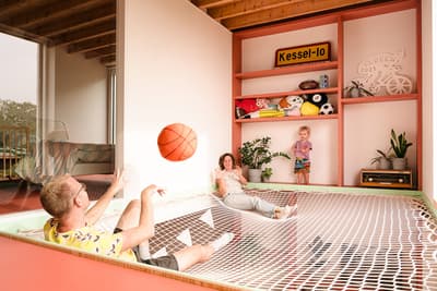 Architectural project - indoor greenery, red accents, creative design, family interaction, kids room, spacious room, relaxation space, wood, timber, playful design, pastel colors, warm tones, green, exposed beams, recreational area, beige, natural wood, timber beams, leisure space, eco materials, casual seating, light tones, inviting home, open layout, family gathering, child friendly, cozy atmosphere, bright interior, contemporary vibe, playful space, open shelving, red