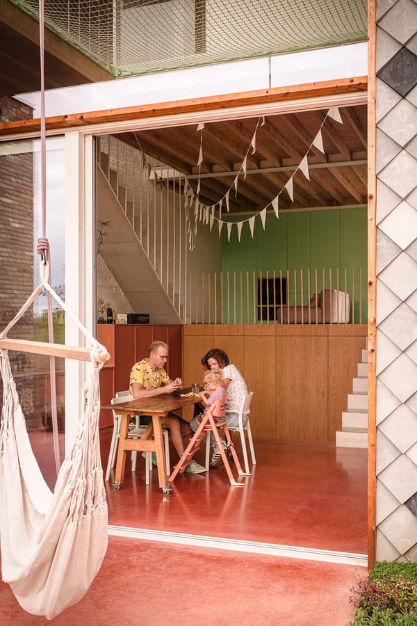 Architectural project - red floor, wood furniture, mezzanine, homey atmosphere, pastel pink, wood, timber, natural light, sustainable design, glass, warm tones, green, exposed beams, daylight, brown, modern design, wooden beams, rustic modern, Scandinavian style, glass doors, cozy space, pastel green, modern rustic, eco home, contemporary home, indoor outdoor, white, inviting home, Nordic style, plaster, timber ceiling, comfortable home, relaxed living, casual living, open layout, open plan, living area, dining area, wooden table, rustic design, terracotta, warm vibe, family home, sliding doors, wood ceiling, wooden stairs, kid friendly, terracotta floor, staircase, family-friendly, red, green wall