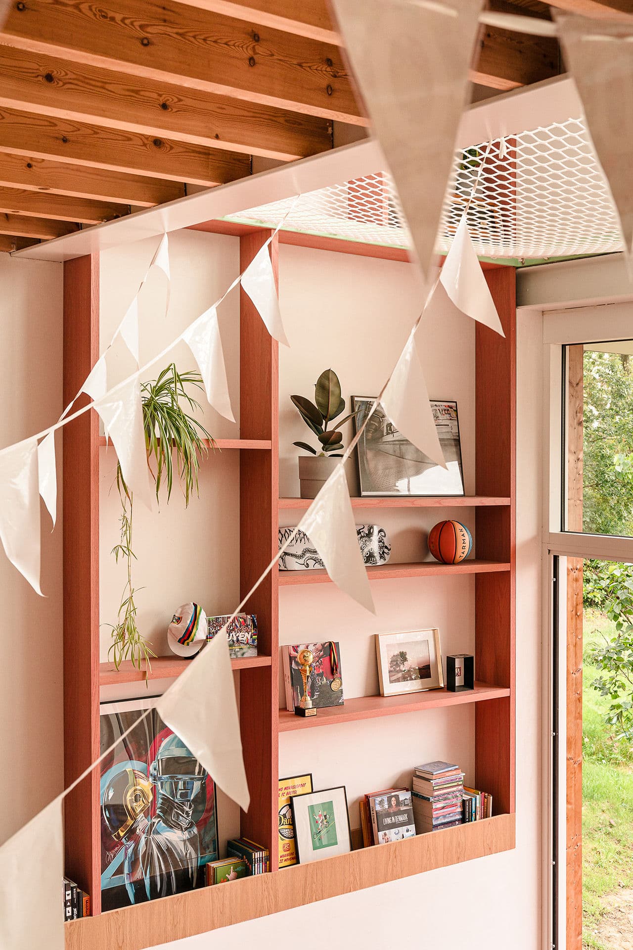 Architectural project - red accents, personal space, homely atmosphere, timber shelf, wooden details, plant decor, green tones, natural materials, wood, timber, relaxed vibe, natural light, rustic touch, warm tones, eco design, neutral tones, exposed beams, ceiling beams, daylight, beige, light wood, multifunctional space, compact space, sunlight, honey wood, timber beams, Scandinavian style, casual space, nature view, indoor outdoor, white, inviting home, cozy corner, home office, wood ceiling, greenery view, sustainable living, wooden shelves, modern interior, open shelving, indoor plants, living space, playful decor, reading corner