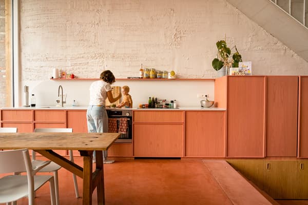 Architectural project - sustainability, dining room, dining chairs, wood table, warm textures, simple shelving, pink floor, indoor space, pink, wood, playful design, natural light, sustainable design, warm tones, functional space, daylight, beige, concrete, light wood, Scandinavian style, minimalist style, vibrant colors, vibrant space, creative space, white, eco friendly home, cozy vibe, Nordic style, textured wall, plaster wall, plaster, family kitchen, home kitchen, casual living, open layout, open plan, dining area, wooden table, white chairs, inviting space, warm atmosphere, child friendly, bright interior, modern kitchen, renovation, concrete wall, open shelving, indoor plant, green plant, kitchen, ceramic, family-friendly, remodel