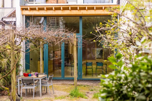 Architectural project - home extension, modern patio, garden furniture, folding chairs, backyard design, pergola design, outdoor oasis, minimalist outdoor, natural materials, wood, timber, metal, timber frame, natural light, outdoor living, glass, warm tones, eco design, contemporary style, grey, green, neutral tones, beige, daylight optimization, minimalist vibe, wood structure, sustainable building, green architecture, biophilic design, sustainable home, large windows, indoor outdoor, open plan, inviting space, alfresco dining, casual dining, cozy atmosphere, relaxed setting, garden view, residential architecture, bright interior, family home, modern home, patio area, outdoor dining, urban garden, glass facade