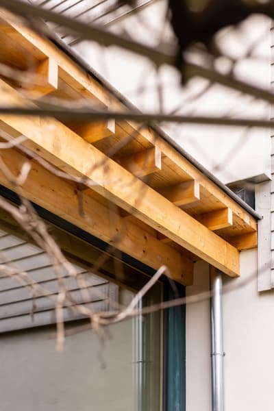 Architectural project - pergola, timber beam, exterior finish, outdoor detail, eaves, wooden eave, timber eave, building exterior, minimal design, architectural detail, sustainable design, warm tones, contemporary architecture, exposed beams, timber facade, architectural elements, timber detail, exterior design, light wood, natural wood, eco friendly, modern design, timber construction, simple design, honey wood, facade detail, natural textures, eco materials, wood construction, light tones, warm wood, structural detail, construction detail, timber cladding, wood cladding, modern architecture, residential architecture, sustainable material, natural construction, wooden facade, wooden structure, earthy textures, home renovation