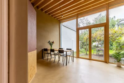 Architectural project - dining chairs, family dining, home dining, cozy dining, simple table, open dining, garden connection, minimalist dining, black chairs, renovation design, smooth wall, wide door, wood, timber, relaxed vibe, natural light, sustainable design, glass, warm tones, eco design, neutral tones, exposed beams, daylight, beige, brown, light wood, natural wood, rustic vibe, honey wood, rustic modern, natural textures, Scandinavian style, casual space, earth tones, modern rustic, eco home, sustainable home, large windows, indoor outdoor, cozy vibe, inviting home, Nordic style, plaster wall, plaster, timber ceiling, open layout, dining table, garden dining, garden view, warm vibe, glass door, modern style, wood ceiling