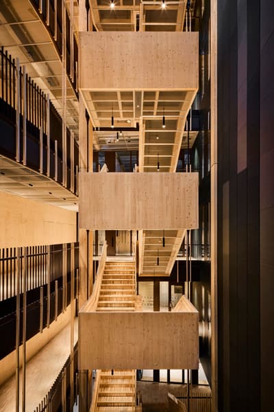 Architectural project - open walkway, golden tones, community building, cultural space, timber texture, layered architecture, structural elegance, natural materials, wood, timber, sustainable design, natural tones, exposed beams, beige, light wood, eco friendly, wood beams, timber beams, contemporary design, minimalist design, timber walls, cross laminated timber, Nordic design, modern architecture, wood walls, timber interior, inviting space, wood texture, warm atmosphere, Scandinavian design, bright interior, interior space, public building, architectural rhythm, warm palette, atrium, high ceiling, double height, wood interior