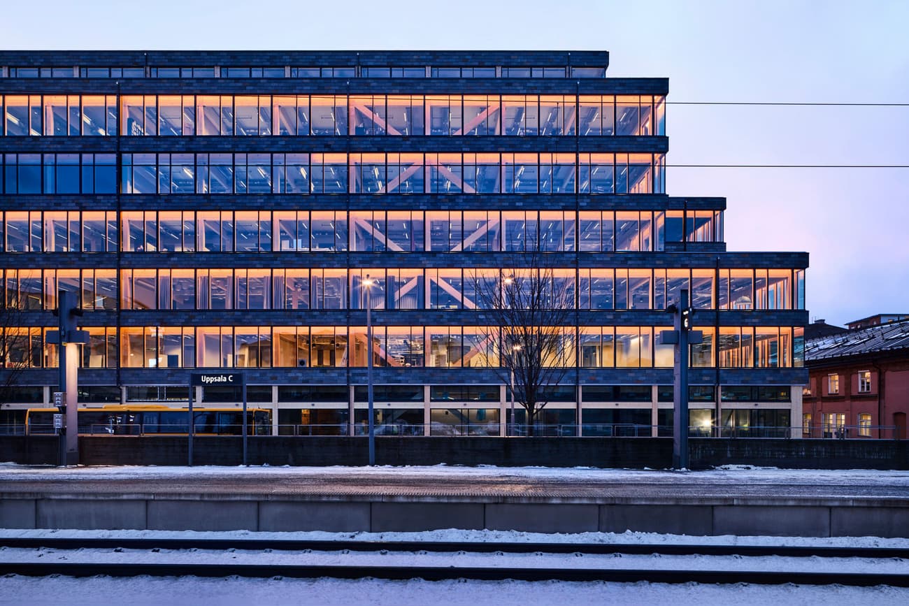 Architectural project - linear design, vertical lines, urban office, contemporary office, commercial building, industrial look, evening ambiance, landmark building, grid pattern, office building, corporate building, eco-friendly design, sustainable materials, urban setting, steel, metal, cityscape, passive design, glass, urban landscape, grey, urban development, city architecture, evening light, urban planning, minimalist facade, industrial style, blue, glass panels, steel structure, urban space, urban design, modern facade, clean lines, energy efficient, warm light, reflective surface, sleek design, urban architecture, glass facade, modern urban