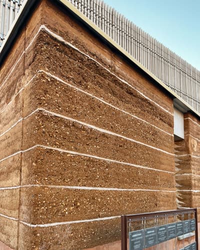Architectural project - natural facade, minimal facade, sustainable, earthy aesthetic, earth wall, earth architecture, facade cladding, layered texture, building exterior, earth, natural materials, eco-friendly design, raw materials, passive design, sustainable design, warm tones, natural tones, eco design, sustainable architecture, beige, brown, architectural facade, exterior wall, facade detail, architectural texture, contemporary design, minimalist design, rammed earth, rammed earth wall, green architecture, earthy texture, earth tones, earth construction, modern facade, clean lines, beige tones, rough texture, organic architecture, environmental design, rustic facade, rustic wall, rustic architecture, sustainable material, textured facade, brown tones, warm, natural finishes, eco facade