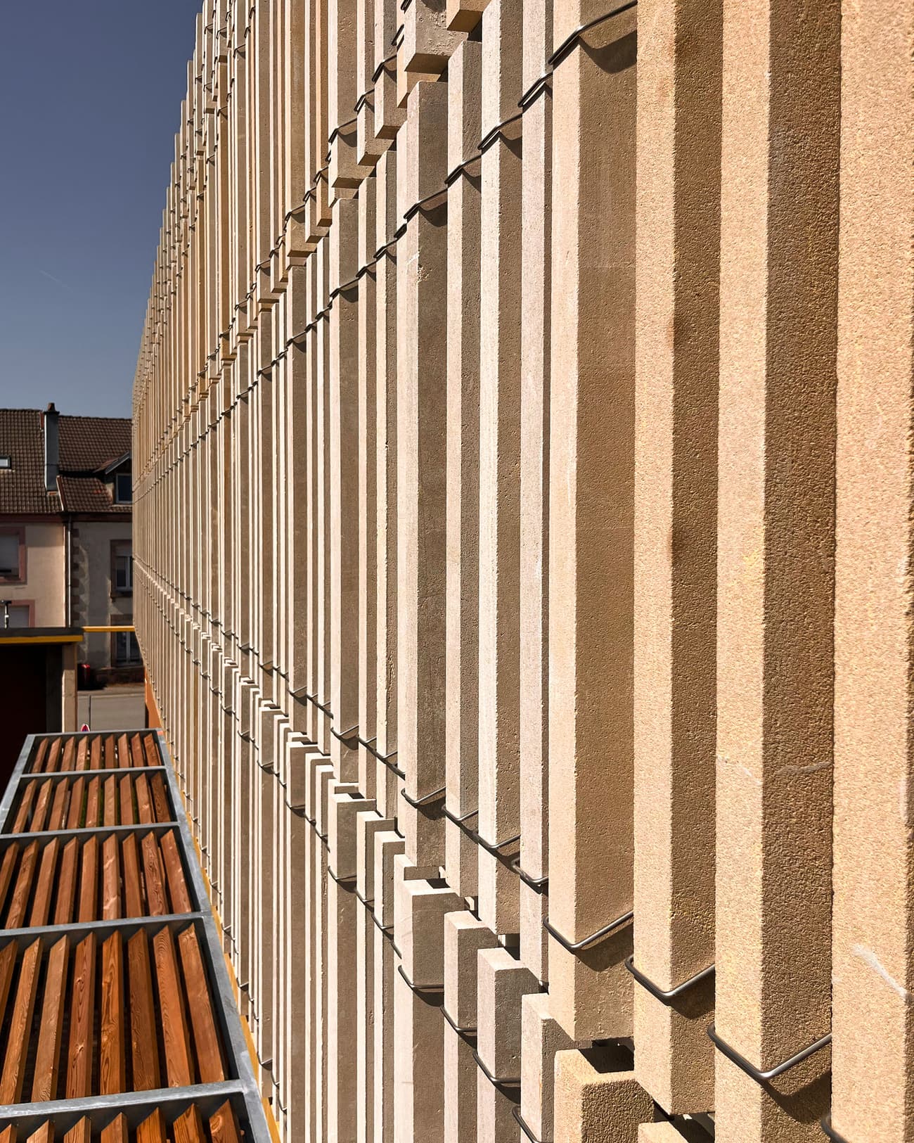 Architectural project - urban building, linear design, vertical elements, repetitive elements, streamlined design, grid pattern, daylight capture, rhythmic facade, building exterior, architectural detail, contemporary style, neutral tones, city architecture, exterior design, building facade, architectural facade, facade detail, minimalist aesthetics, urban design, modern architecture, warm beige, textured walls, textured facade, geometric facade, facade rhythm, linear facade, minimalist lines, urban exterior