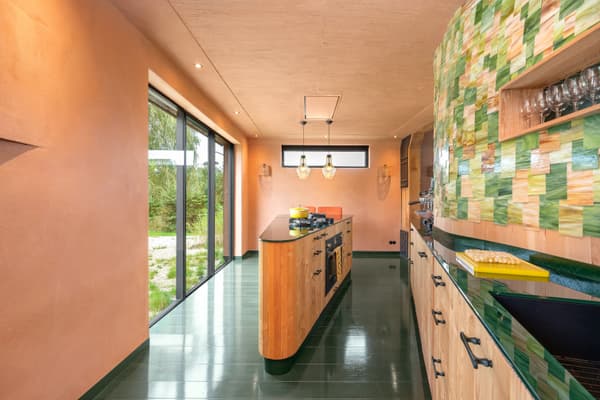 Architectural project - custom design, residential kitchen, pendant lights, green tiles, sleek cabinets, colorful kitchen, glazed tiles, orange walls, terrazzo countertop, handleless cabinets, contemporary lighting, artistic kitchen, eco-friendly design, sustainable materials, timber, playful design, natural light, glass, warm tones, neutral tones, functional space, daylight, light wood, Scandinavian style, minimalist style, glass doors, vibrant colors, creative space, eco home, sustainable home, indoor outdoor, large window, energy efficient, plaster, bright kitchen, open layout, panoramic view, inviting space, cozy atmosphere, garden view, modern kitchen, kitchen island, nordic influence, innovative materials, unique design, renovation, kitchen, ceramic tiles, remodel