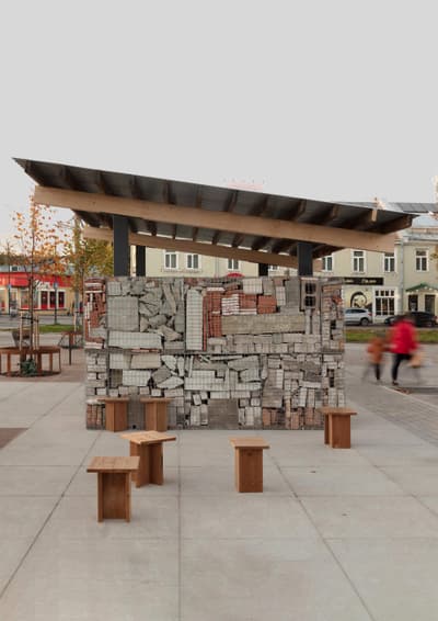 Architectural project - wooden benches, light grey, urban renewal, brick wall, raw textures, urban pavilion, public square, street architecture, repurposed materials, open shelter, public pavilion, tile wall, eco pavilion, timber seating, minimalist benches, urban seating, exposed roof, modern gazebo, material mix, reused bricks, neighborhood center, meeting spot, pedestrian zone, town center, plaza design, wood, timber, outdoor space, sustainable design, recycled materials, warm tones, community space, multifunctional area, grey, civic space, beige, brown, concrete, casual seating, social hub, urban design, vibrant space, street furniture, natural palette, roof structure, outdoor gathering, brick, ceramic, mixed materials