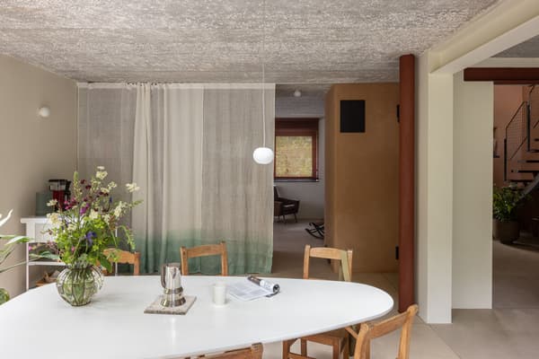 Architectural project - curtain divider, dining room, dining chairs, home dining, cozy dining, white table, round table, stone vase, timber chair, wood chair, room divider, textured ceiling, plaster ceiling, indoor space, soft lighting, wood, timber, natural light, green, neutral tones, daylight, beige, brown, simple design, rustic modern, natural textures, Scandinavian style, minimalist design, modern rustic, biophilic design, eco home, sustainable home, white, inviting home, Nordic style, plaster, rustic style, comfortable home, relaxed living, casual living, open layout, open plan, dining area, earthy tones, earthy textures, modern style, renovation, ceramic, indoor plants, green plants, remodel