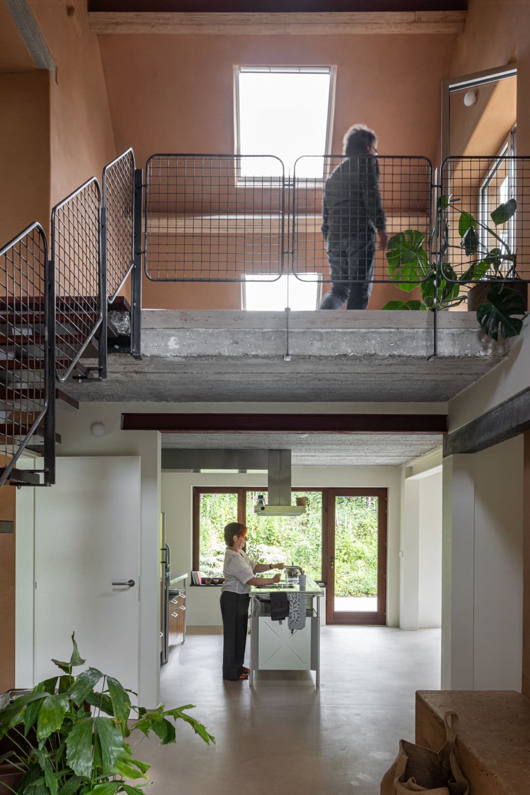 Architectural project - metal railing, concrete ceiling, loft apartment, two-storey, mezzanine, plant decor, stylish interior, functional home, natural materials, eco-friendly design, timber, industrial design, city living, metal, natural light, grey, exposed beams, industrial vibe, beige, brown, concrete, light wood, rustic modern, modern rustic, sustainable home, contemporary home, white, cozy vibe, plaster, airy space, open layout, open plan, minimalist decor, earthy tones, warm atmosphere, greenery, family home, modern kitchen, sleek design, kitchen island, compact living, concrete floor, skylight, indoor plants, bright home, urban living
