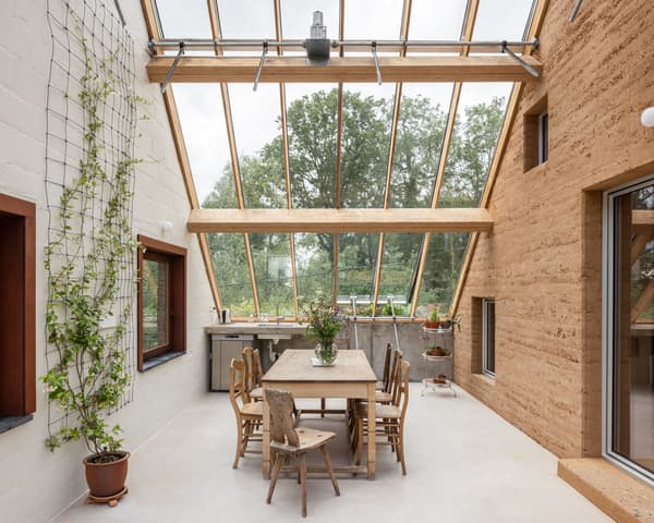 Architectural project - indoor greenery, indoor garden, wood furniture, glass roof, earth wall, kitchen area, house plants, wood, timber, natural light, sustainable design, recycled materials, glass, warm tones, neutral tones, daylight, beige, brown, concrete, farmhouse style, honey wood, wood beams, timber beams, natural textures, minimalist design, eco-friendly materials, rammed earth, modern rustic, biophilic design, eco home, sustainable home, passive house, natural ventilation, light filled, white, cozy vibe, landscape view, rustic style, open layout, open plan, dining area, inviting space, nature-inspired, bright interior, plaster walls, earthy textures, clay plaster, skylight, vertical garden