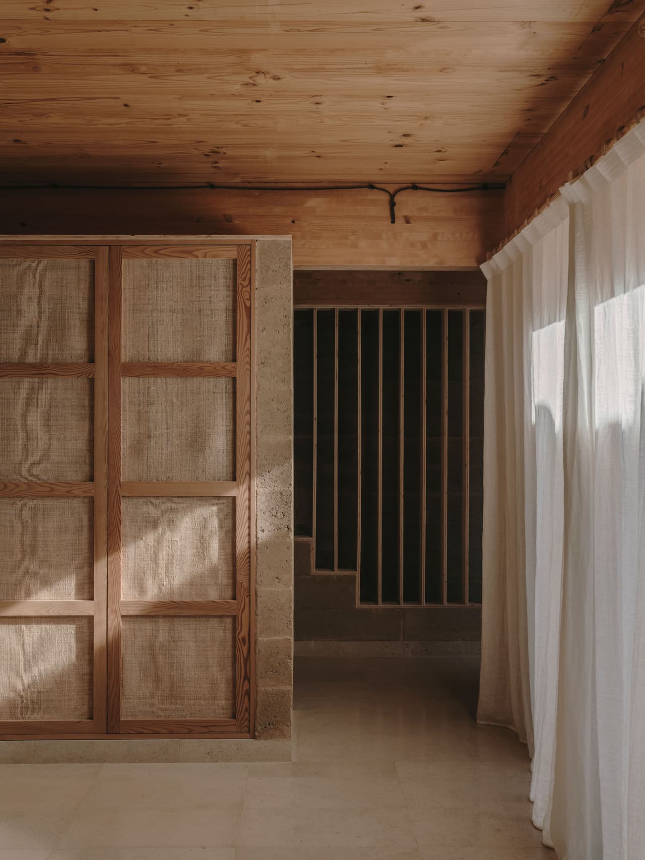 Architectural project - wood wall, neutral interior, subtle elegance, Scandinavian touch, calm interior, linen curtains, partition wall, wooden partition, timeless style, refined simplicity, home setting, cocooning space, natural materials, soft lighting, sustainable materials, wood, timber, raw materials, natural light, passive design, warm tones, eco design, daylight, beige, light wood, organic design, private retreat, minimalist design, serene space, exposed wood, modern rustic, cozy vibe, stone, wood texture, timber ceiling, airy space, earthy tones, warm atmosphere, stone floor, wood ceiling, timber wall, tactile surfaces, linen, Japandi style, residential interior, woven texture, light flooring