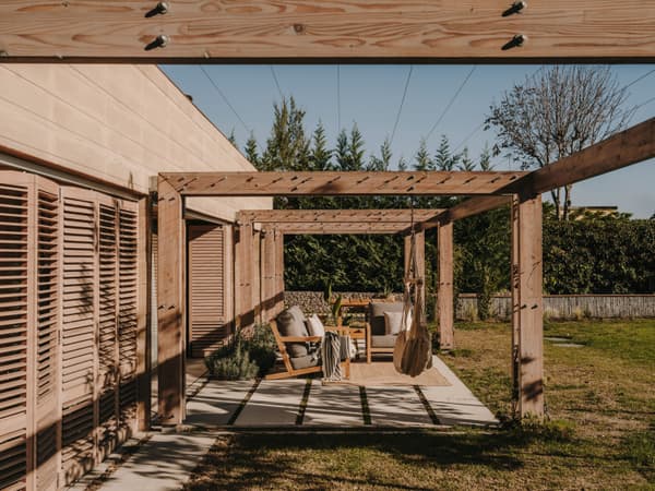 Architectural project - wooden shutters, outdoor lounge, wooden pergola, timber pergola, garden terrace, patio seating, outdoor furniture, al fresco, garden decor, landscaped garden, sustainable materials, wood, timber, relaxed vibe, natural light, outdoor living, warm tones, eco design, outdoor area, neutral tones, beige, natural setting, timber construction, rustic modern, wood structure, timber walls, modern rustic, earthy tones, warm atmosphere, cozy outdoor, garden design, relaxing space, garden retreat, landscape design, sunny day, backyard retreat, garden view, nature integration, outdoor shelter, open air, lounge chairs, comfortable seating, inviting exterior, garden seating, residential garden, home garden, green space