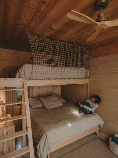 Architectural project - organic elements, rustic interior, hygge, bunk bed, wooden bunk, kids room, child room, small space living, compact room, layered lighting, indoor comfort, woven details, woven net, warm feel, natural materials, wood, timber, natural light, inviting atmosphere, warm tones, eco design, neutral tones, functional space, daylight, beige, brown, light wood, honey wood, cozy space, timber walls, rammed earth, rammed earth wall, sustainable home, beige tones, warm ambiance, earthy vibe, rustic style, minimalist decor, cozy corner, cabin style, light timber, family home, home design, earthy textures, wood ceiling, interior design, cozy bedroom, cabin vibe