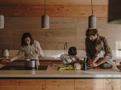 Architectural project - kitchen counter, pendant lights, wooden kitchen, sustainable kitchen, timber cabinets, ceiling lights, cooking space, family cooking, kitchen activities, home cooking, everyday kitchen, natural design, kitchen essentials, family interaction, indoor space, natural materials, soft lighting, wood, timber, contemporary style, neutral tones, beige, brown, light wood, eco friendly, rustic charm, minimalist vibe, relaxed atmosphere, modern rustic, textured wall, stone, cozy kitchen, family kitchen, home kitchen, open layout, inviting space, earthy tones, casual dining, stone wall, modern home, wood cabinetry, kitchen island, home interior, interior design, warm lighting, sustainable living, warm kitchen, family-friendly