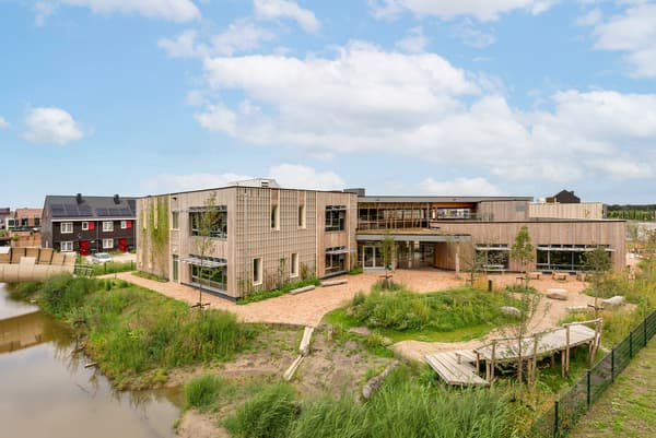 Architectural project - landscaping, riverbank, rural community, building with nature, natural materials, sustainable materials, outdoor space, sustainable design, natural tones, modular design, contemporary style, green, gathering space, recreational area, landscape architecture, beige, timber facade, exterior design, light wood, daylight optimization, eco friendly, natural setting, timber construction, minimalist design, community center, eco building, circular construction, biophilic design, passive house, natural ventilation, modern architecture, energy efficient, open layout, garden view, nature integration, wooden cladding, wooden structure, water feature, modern rural, low carbon building, public building, green roof, innovative architecture, inviting facade
