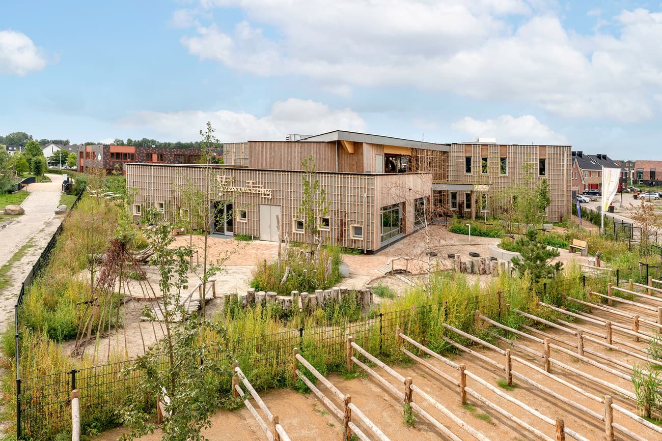 Architectural project - airy structure, landscaped garden, environmental focus, eco-friendly landscape, plant-filled exterior, eco playground, grid design, architectural grid, open environment, environmental planning, outdoor classroom, eco exterior, natural materials, sustainable materials, wood, timber, natural light, passive design, sustainable design, recycled materials, warm tones, green building, outdoor area, green, timber structure, daylight, beige, wood facade, timber facade, low carbon design, community center, eco construction, natural landscape, green architecture, earth tones, biophilic design, timber cladding, wood cladding, harmonious design, energy efficient, nature-inspired, landscape design, nature integration, eco architecture, educational building, green roof, outdoor learning, modern school