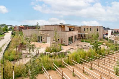 Architectural project - airy structure, landscaped garden, environmental focus, eco-friendly landscape, plant-filled exterior, eco playground, grid design, architectural grid, open environment, environmental planning, outdoor classroom, eco exterior, natural materials, sustainable materials, wood, timber, natural light, passive design, sustainable design, recycled materials, warm tones, green building, outdoor area, green, timber structure, daylight, beige, wood facade, timber facade, low carbon design, community center, eco construction, natural landscape, green architecture, earth tones, biophilic design, timber cladding, wood cladding, harmonious design, energy efficient, nature-inspired, landscape design, nature integration, eco architecture, educational building, green roof, outdoor learning, modern school