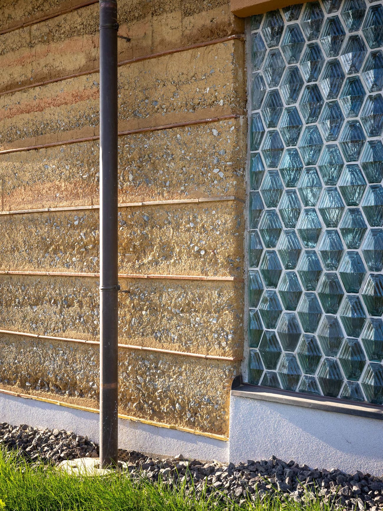 Architectural project - raw finishes, earth wall, tactile design, glass bricks, natural aesthetic, natural materials, architectural detail, sustainable materials, organic texture, passive design, sustainable design, green building, beige, brown, exterior wall, low carbon design, eco friendly, sunlight, rustic modern, rammed earth, thermal mass, earth tones, modern rustic, earthy vibe, warm colors, nature-inspired, rustic wall, environmental architecture, natural wall, eco architecture, sustainable facade, textured facade, facade design, architectural rhythm, energy efficiency, texture contrast, eco facade