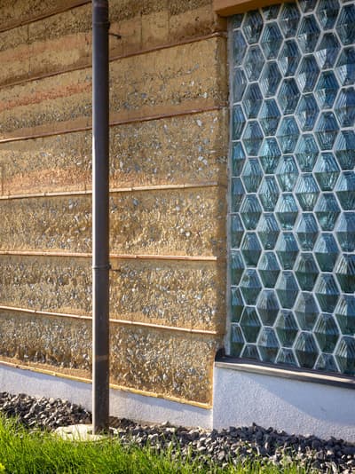Architectural project - raw finishes, earth wall, tactile design, glass bricks, natural aesthetic, natural materials, architectural detail, sustainable materials, organic texture, passive design, sustainable design, green building, beige, brown, exterior wall, low carbon design, eco friendly, sunlight, rustic modern, rammed earth, thermal mass, earth tones, modern rustic, earthy vibe, warm colors, nature-inspired, rustic wall, environmental architecture, natural wall, eco architecture, sustainable facade, textured facade, facade design, architectural rhythm, energy efficiency, texture contrast, eco facade