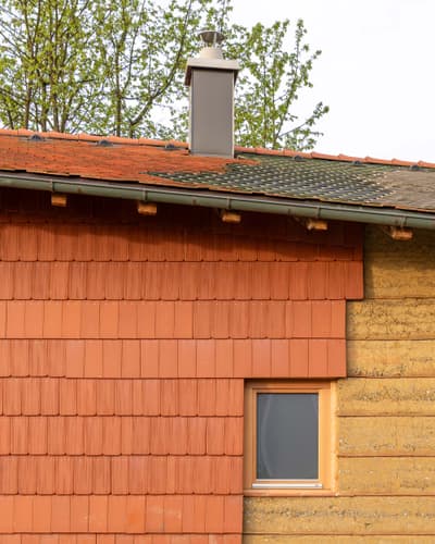 Architectural project - outdoor wall, terracotta tiles, natural design, red tones, ecological building, warm facade, red tiles, clay facade, classic design, traditional facade, natural materials, architectural detail, wood, passive design, warm tones, eco design, grey, beige, exterior wall, rural architecture, vernacular architecture, rustic charm, rammed earth, rammed earth wall, earth tones, rural home, wood accents, stone, beige tones, terracotta, rustic facade, shingle roof, earthy palette, cozy exterior, earthy facade, countryside house, sustainable house, textured facade, simple lines, facade texture, window detail, clay tiles, ceramic, ceramic tiles, natural finishes, red