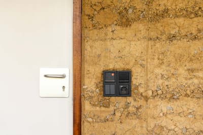 Architectural project - contrast design, modern touch, minimalist door, rustic appeal, earthy finish, white door, rustic vibes, neutral design, mud wall, natural materials, sustainable design, beige, brown, eco friendly, simple design, black, neutral colors, natural finish, rammed earth, modern rustic, white, textured wall, plaster wall, beige tones, rustic style, earthy tones, warm atmosphere, rustic design, handcrafted look, rustic wall, earthy textures, clay wall, low-tech, sustainable living, warm palette, warm aesthetic, minimalistic style, natural look