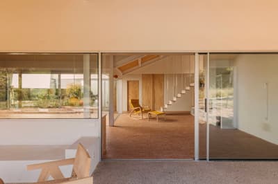 Architectural project - airy interior, living room, indoor garden, stylish interior, elegant simplicity, organic feel, sliding glass, modern minimal, brick floor, spacious feeling, bright living space, relaxing vibe, zen ambiance, natural materials, wood, timber, natural light, glass, eco design, neutral tones, daylight, beige, light wood, minimalist design, sustainable home, passive house, contemporary home, clean lines, indoor outdoor, white, inviting home, modern architecture, energy efficient, wood accents, timber accents, airy space, open layout, open plan, glass walls, warm atmosphere, terracotta, brick, cozy atmosphere, residential design, relaxing space, garden view, lounge chair, lounge area, seamless indoor outdoor, simple lines, wooden furniture, calm setting, terracotta floor