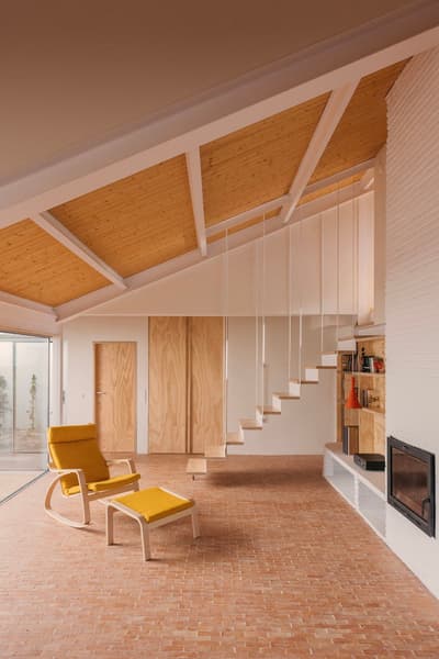Architectural project - cozy living, architectural home, floating stairs, brick floor, open living space, minimalist staircase, yellow chair, mustard chair, relaxing atmosphere, inviting ambiance, interior remodeling, warm interior, wood, timber, natural light, yellow, warm tones, neutral tones, exposed beams, daylight, beige, light wood, airy design, honey wood, Scandinavian style, neutral palette, minimalist design, white, eco friendly home, Nordic style, timber ceiling, open plan, terracotta, brick, residential design, reading nook, modern fireplace, lounge chair, modern home, bright space, earthy textures, wood ceiling, sustainable living, indoor outdoor flow, built-in shelving, terracotta floor, home renovation, comfortable space