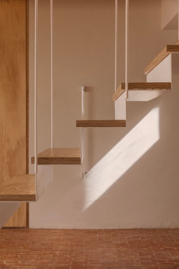 Architectural project - metal railing, minimalist stairs, modern staircase, urban loft, cozy feel, open risers, loft vibe, floating stairs, suspended stairs, wooden treads, white railing, oak wood, plywood steps, small stair, studio apartment, wood and metal, wood and brick, indoor space, architectural detail, metal, natural light, shadow play, sustainable design, warm tones, daylight, plywood, beige, light wood, compact space, Scandinavian style, light brown, neutral palette, minimalist design, eco-friendly materials, earthy texture, rustic texture, contemporary home, clean lines, white, airy space, warm atmosphere, terracotta, beige wall, sleek design, terracotta floor, Japandi style, residential interior