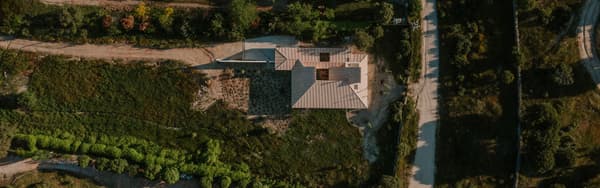 Architectural project - off-grid, rural escape, green environment, landscape, open surroundings, tiled roof, rural, landscaping, terracotta roof, regional architecture, pastoral setting, quiet setting, country style, environmental integration, nature surroundings, large plot, spacious land, natural terrain, natural path, breathable layout, earth colors, rural plot, rustic palette, stone path, outdoor space, sustainable design, green, beige, brown, exterior design, eco friendly, rustic roof, farmhouse style, vernacular architecture, rustic charm, natural landscape, earth tones, scenic view, rural home, rural living, earthy tones, nature-inspired, traditional design, nature retreat, landscape design, greenery, garden landscape, countryside living, secluded home, countryside house, garden path, organic shapes, aerial view, rural retreat, clay tiles, country home, wooden door