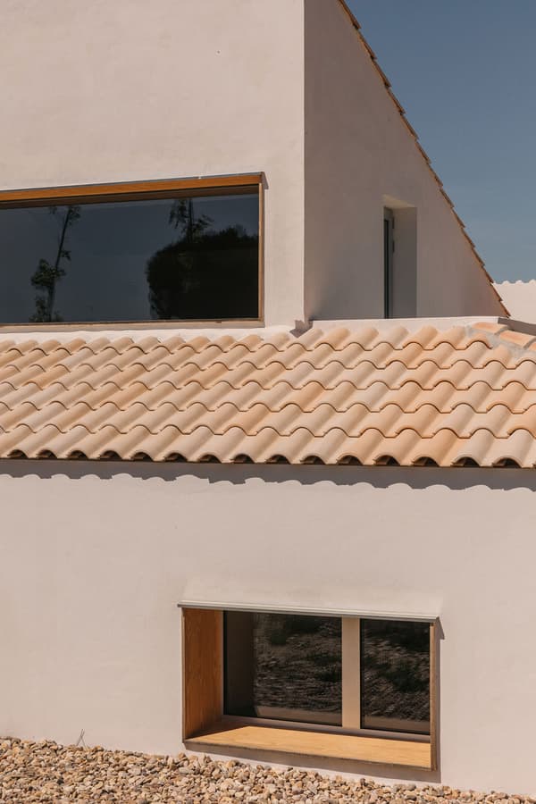 Architectural project - natural stone, exterior facade, architectural roofline, Mediterranean influences, retreat home, tile, countryside vibe, residential exterior, warm minimalism, terracotta roof, villa, modern villa, minimalist villa, tile roof, modern Mediterranean, contemporary rustic, stone details, minimal exterior, natural materials, outdoor space, natural light, passive design, sustainable design, warm tones, daylight, exterior design, rustic charm, leisure space, serene atmosphere, tranquil setting, earth tones, eco home, modern facade, clean lines, white walls, energy efficient, stone, plaster, Mediterranean style, terracotta, warm beige, rural setting, landscape design, vacation home, plaster walls, earthy textures, simple architecture, garden space, light beige