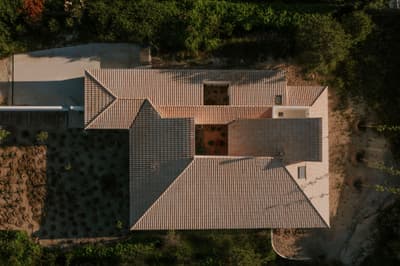 Architectural project - green oasis, minimalist garden, texture rich, integration with nature, minimalist landscape, terracotta roof, tile roof, outdoor garden, lush landscape, warm climate design, secluded house, roof garden, privacy-focused, environmental blend, spacious garden, serene environment, sustainable design, warm tones, neutral tones, beige, daylight optimization, natural setting, biophilic design, sustainable home, natural ventilation, contemporary home, eco friendly home, harmonious design, earthy tones, pitched roof, nature-inspired, Mediterranean style, terracotta, tranquil vibe, landscape design, garden view, residential architecture, eco house, private residence, passive solar, green surroundings, suburban home, courtyard, aerial view, clay tiles, modern house