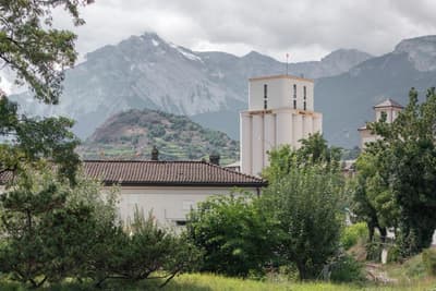 Architectural project - rural landscape, eco-friendly area, cloudy sky, roof tiles, calm surroundings, outdoor environment, historic building, peaceful view, mountain backdrop, vegetated area, local vegetation, outdoor landscape, village scene, picturesque view, idyllic setting, rural homes, nature surrounds, quiet living, scenic retreat, scenic mountains, community area, village life, neighborhood setting, forested area, picturesque landscape, outdoor space, rural architecture, rustic vibe, rustic charm, traditional building, serene atmosphere, scenic view, tranquil vibe, greenery, natural environment, nature escape, countryside living, peaceful living, lush greenery, greenery view, residential area, sustainable living, nature setting, natural beauty