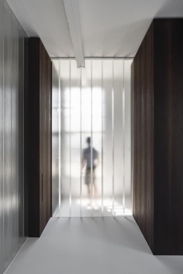 Architectural project - refined style, urban chic, subtle elegance, minimalist hall, streamlined design, modern corridor, white floor, glass corridor, glass hallway, brown wood walls, sharp geometry, visual depth, spatial contrast, sophisticated space, harmonious space, architectural refinement, light play, eco-friendly design, sustainable materials, natural light, warm tones, neutral tones, translucent panels, industrial vibe, brown, visual rhythm, contemporary design, industrial touch, neutral palette, clean lines, light filled, timber cladding, white, sleek design, bright space, calm atmosphere, soft light, vertical panels, modern interior, architectural feature, airy, frosted glass