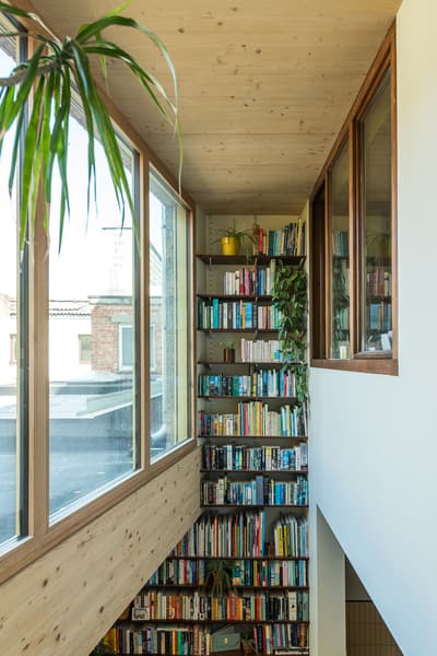 Architectural project - green accents, airy interior, loft vibe, city view, rooftop view, cozy interior, warm interior, wood, timber, natural light, sustainable design, glass, warm tones, neutral tones, exposed beams, daylight, wooden ceiling, light wood, natural wood, sunlight, honey wood, Scandinavian style, minimalist design, rejuvenation space, timber walls, biophilic design, passive house, large windows, white, eco friendly home, Nordic style, energy efficient, timber ceiling, timber shelves, airy space, open plan, inviting space, nature-inspired, tranquil vibe, relaxing space, cozy corner, greenery, glass windows, reading nook, built-in shelves, book nook, home library, modern home, wood paneling, wooden shelves, floor to ceiling, indoor plants, urban home, atrium