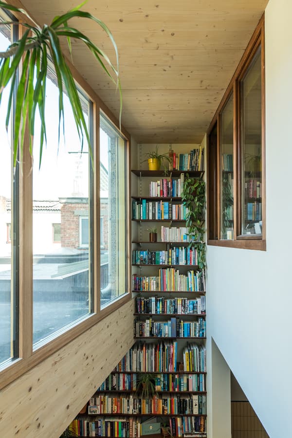 Architectural project - green accents, airy interior, loft vibe, city view, rooftop view, cozy interior, warm interior, wood, timber, natural light, sustainable design, glass, warm tones, neutral tones, exposed beams, daylight, wooden ceiling, light wood, natural wood, sunlight, honey wood, Scandinavian style, minimalist design, rejuvenation space, timber walls, biophilic design, passive house, large windows, white, eco friendly home, Nordic style, energy efficient, timber ceiling, timber shelves, airy space, open plan, inviting space, nature-inspired, tranquil vibe, relaxing space, cozy corner, greenery, glass windows, reading nook, built-in shelves, book nook, home library, modern home, wood paneling, wooden shelves, floor to ceiling, indoor plants, urban home, atrium